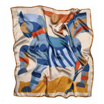 The Sneaky fox silk scarf Dakota by BUTIK KUBIK features a geometric horse motif in blue, orange, and beige with brown trim on a light background. Its gently wrinkled silk fabric adds unique style.
