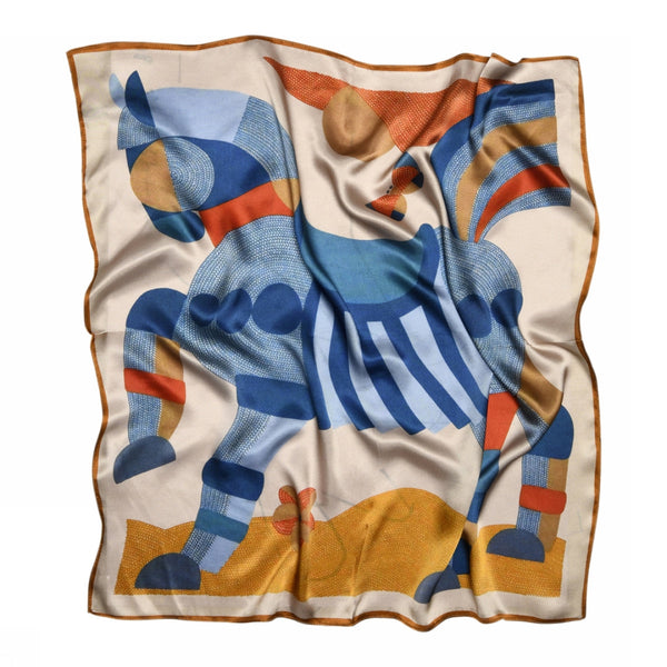 The Sneaky fox silk scarf Dakota by BUTIK KUBIK features a geometric horse motif in blue, orange, and beige with brown trim on a light background. Its gently wrinkled silk fabric adds unique style.