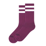 A pair of BUTIK KUBIK American Socks Mid High Plum skate socks with two white stripes near the top, shown side by side on a white background. Made in Barcelona for comfort and style.