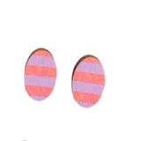 Four oval-shaped Törmi earrings by BUTIK KUBIK, crafted from Finnish Birch and adorned with pink and purple diagonal stripes, are arranged in pairs against a pristine white background.