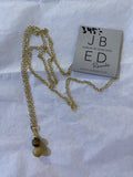 A gold chain necklace with gold and beige round beads, crafted in guldpläterat rostfritt stål, from BUTIK KUBIK’s JBED Jewelry By Elina Dahl - Remake Halsband, displayed on white paper beside a card marked 345:- and elinadahl.com.