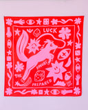 The Tropical Scandinavia scarf Lucky charm by BUTIK KUBIK features a fox amid playful shapes, stars, dice, eyes, clovers, and hands with "LUCK FAVORS THE PREPARED," crafted from organic cotton in bright pink and red.
