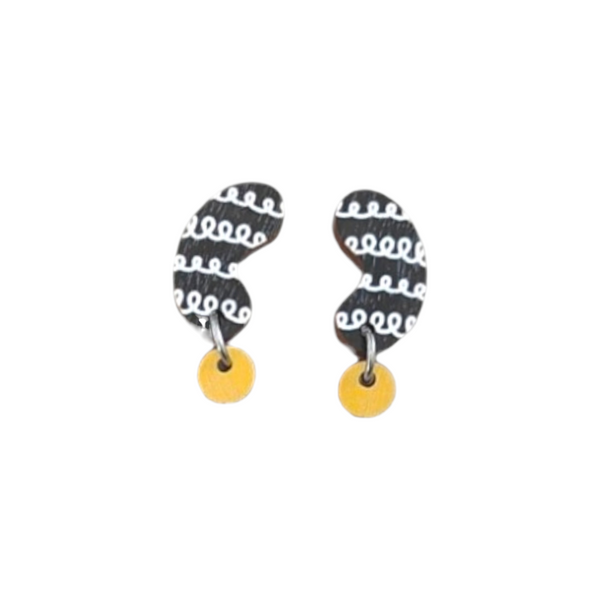 The Törmi papu mini earrings yellow by BUTIK KUBIK feature abstract black and white squiggles with round yellow accents. Made from Finnish Birch plywood with surgical steel hooks, they come in eco-friendly packaging for a sustainable style statement.