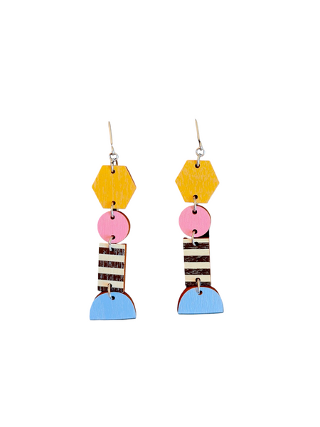 The Törmi Earrings harmonia by BUTIK KUBIK feature hexagon, circle, rectangle, and semicircle shapes in yellow, pink, blue, black, and white. Crafted from Finnish birch plywood with striped and plain designs connected vertically. They include surgical steel posts in eco-friendly packaging.