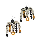 The Törmi Karnevaali earrings white/yellow by BUTIK KUBIK are abstract, mismatched pieces crafted from eco-friendly Finnish birch plywood, featuring black, white, and mustard yellow shapes in a modern design.