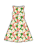 The Cissi och Selma dress Saga Humlesurr Korall by BUTIK KUBIK is a sleeveless, knee-length 50s-style dress with a fitted bodice and flared skirt, featuring a vibrant floral print in white, pink, yellow, and green on white.