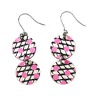 The Törmi Satu earrings pink by BUTIK KUBIK are eco-friendly dangle earrings made from Finnish birch plywood, featuring two circular discs with black and white stripes accented by pink polka dots on a white background.