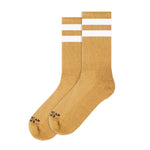 BUTIK KUBIKs American Socks Mid High Mustard are vegan-friendly crew socks in mustard yellow with two white stripes and black text near the toes, perfect for stylish comfort on or off your board.