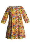 The Cissi och Selma dress Anita Fågeltivoli by BUTIK KUBIK is a colorful tunika made from ekologisk bomullstrikå, showcasing a vibrant floral pattern with large yellow, orange, red, and blue flowers. It features long sleeves, a flared A-line silhouette, and a round neckline.