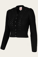 The Emmy - The Scandi Summer Cardi by BUTIK KUBIK is a classic black knit cardigan with a V-neck, intricate patterns, puffed shoulders, thick textured merino wool, matching black buttons, and long sleeves—timeless design.