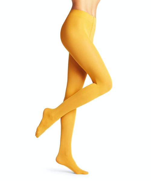 A person is shown from the waist down wearing BUTIK KUBIK Falke pure matte Amber 50 denier yellow pantyhose, one leg slightly bent and the other extended, against a white background.