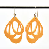 Favoretro Earrings Loops Fuzzy Peach by BUTIK KUBIK: abstract acrylic earrings in vibrant orange with open cut-out shapes, hanging from silver surgical steel hooks, shown against a white background.