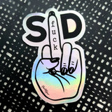 The Favoretro sticker Fuck SD from BUTIK KUBIK depicts a hand with painted nails giving the middle finger, featuring the word "fuck" on the finger and "S" and "D" around it, set against a black and white patterned background.
