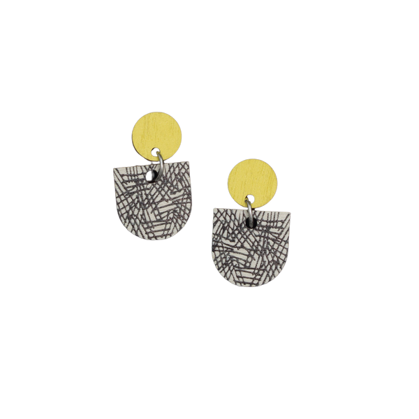 Introducing the Törmi tilkku earrings lime/gray by BUTIK KUBIK: featuring matte gold circular studs with semi-circular Finnish Birch plywood dangles in a black and white crosshatch design. Each pair comes in eco-friendly packaging.