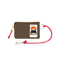 The YKRA Miniwallet Khaki by BUTIK KUBIK is a compact brown wallet with a zipper and colorful mountain YKRA patch. It includes a red rope lanyard with a silver carabiner, ideal for adventures.